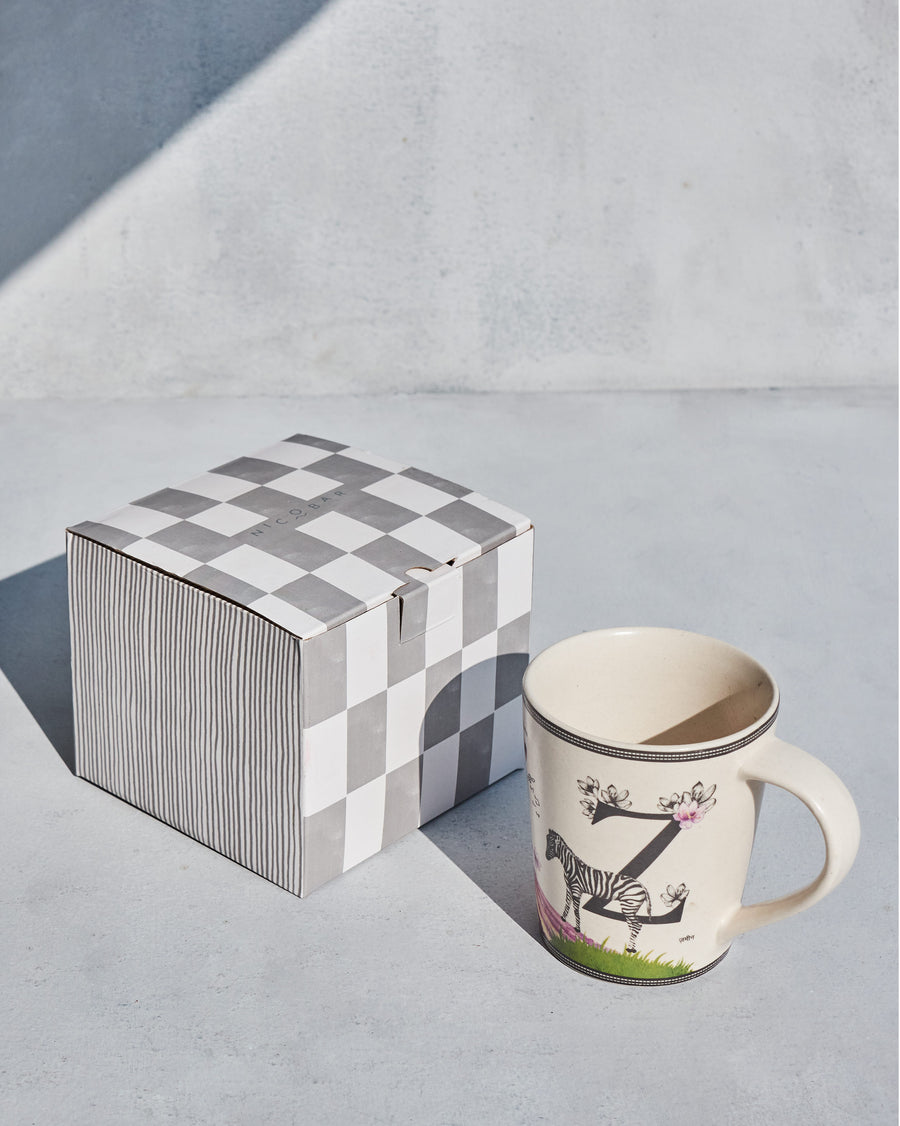 The Zafran Mug beside its chequered Nicobar gift box.