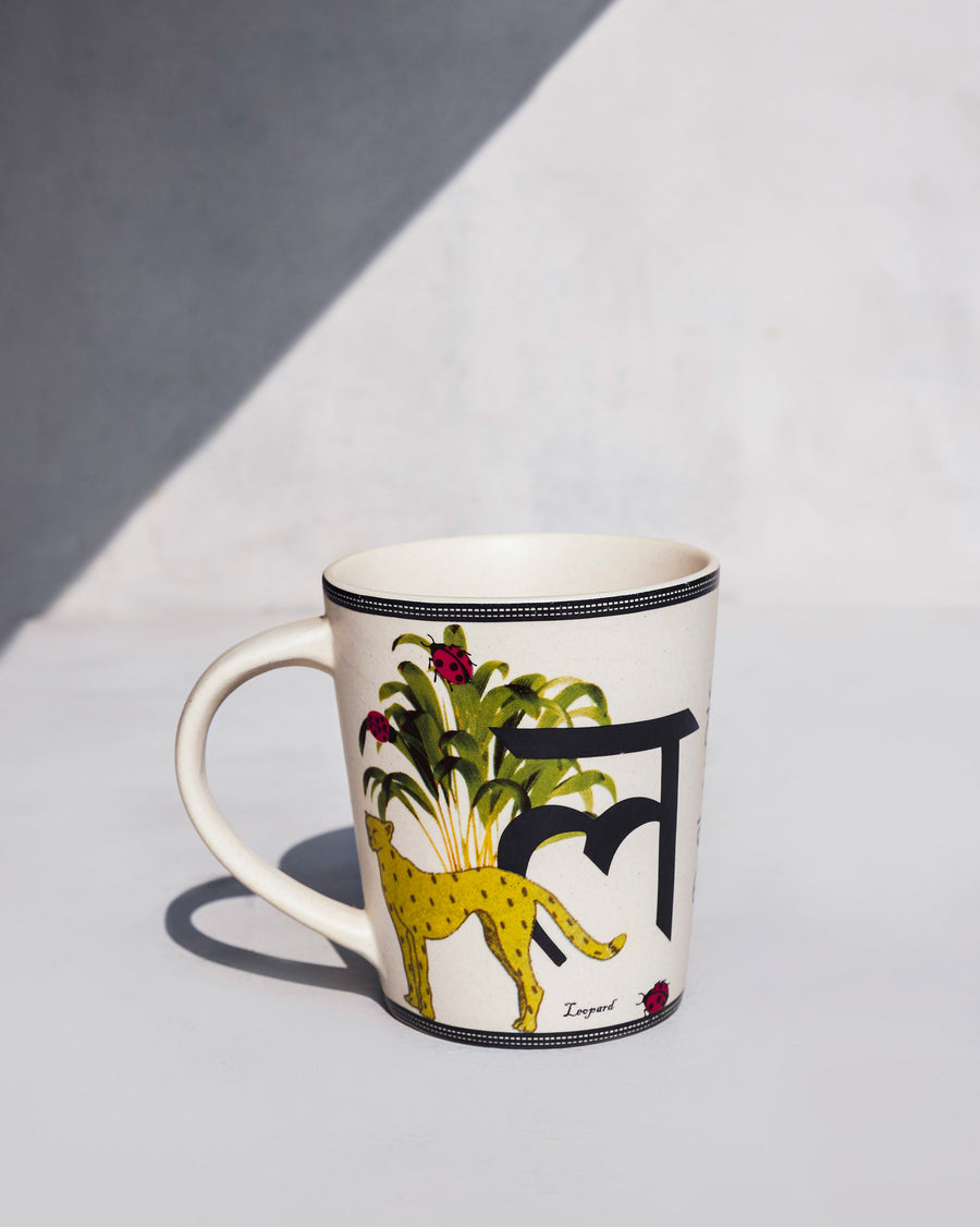 The Langoor Mug side-on, with the letter ल and a leopard.