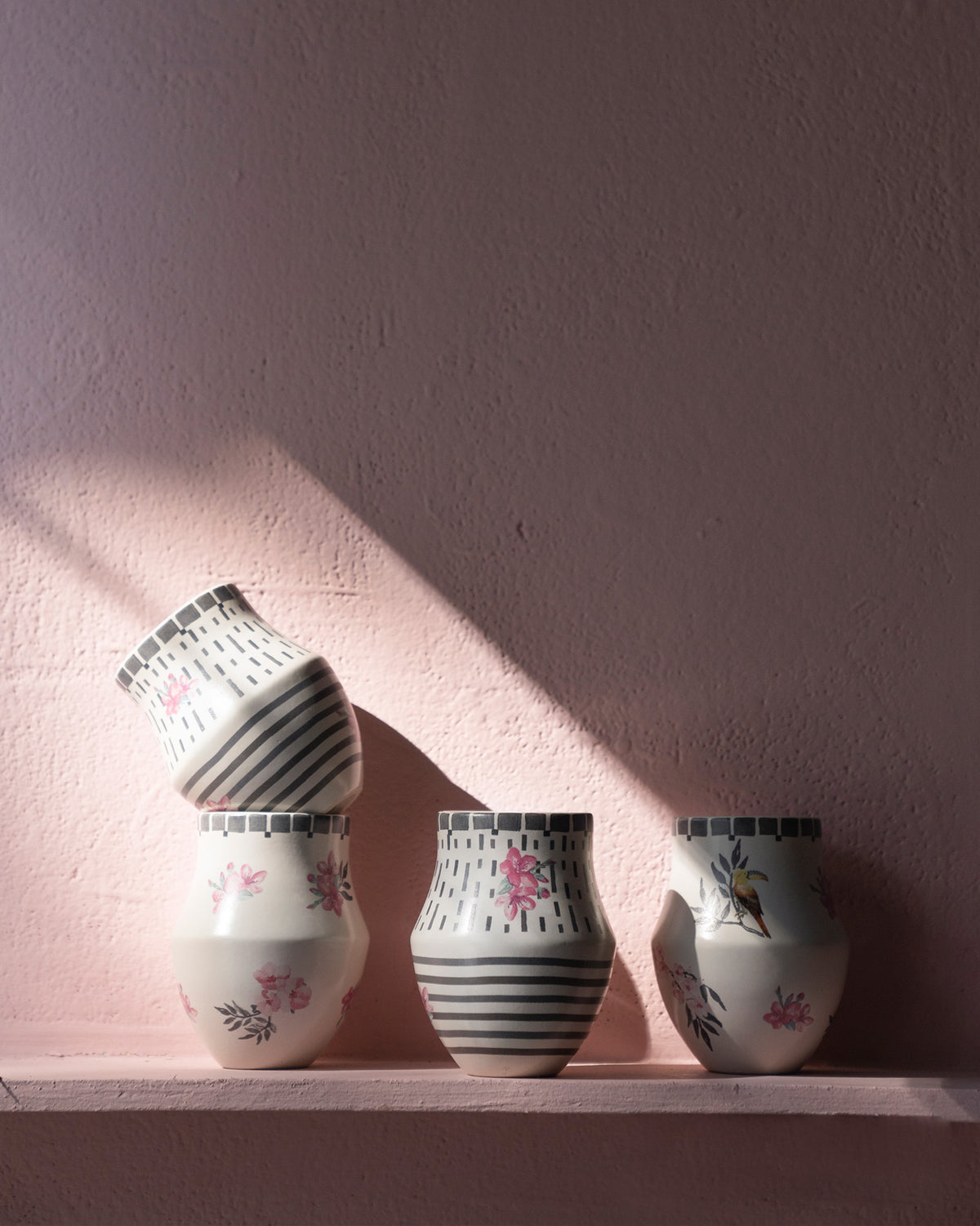 Four Nectar Kulhars with varied stripe, dash and floral designs.