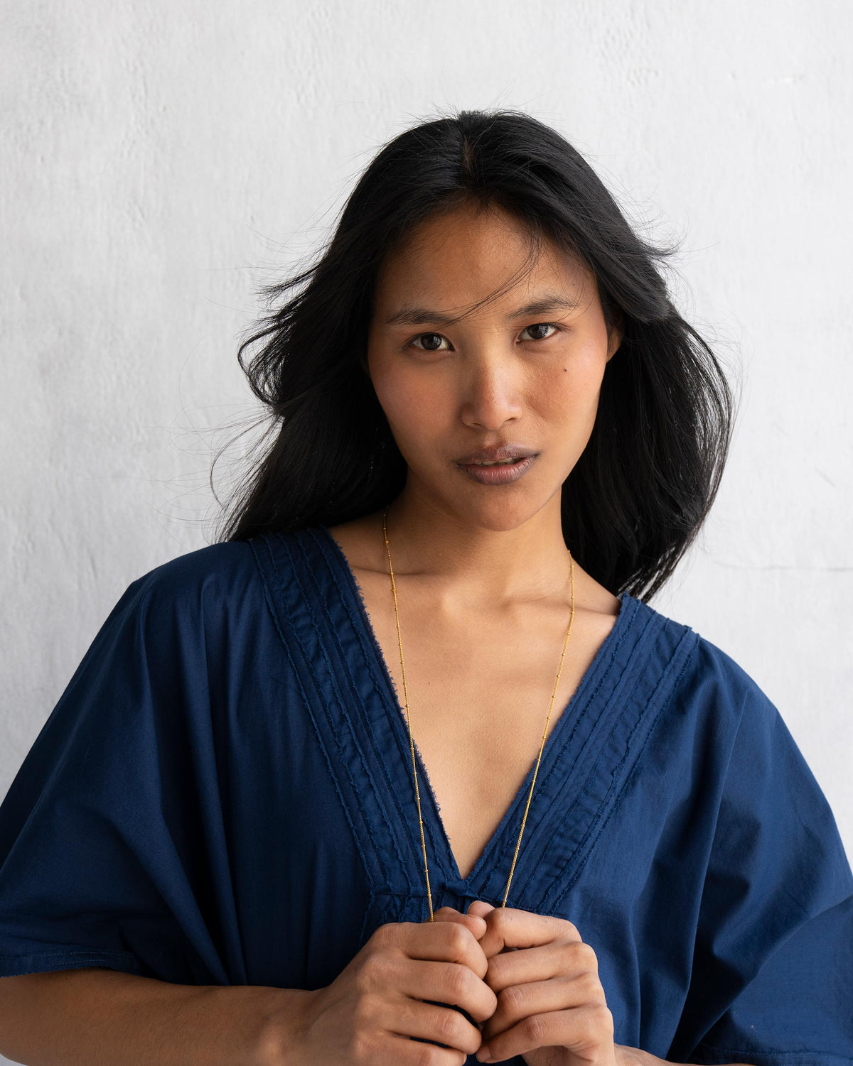 Person holding the ends of Boondi Chain at the neckline.