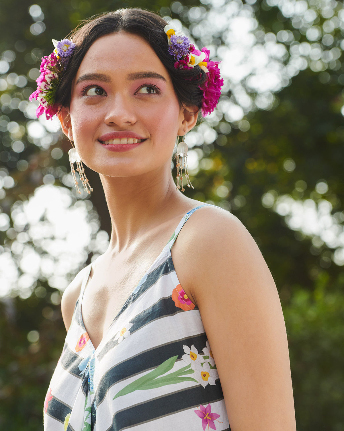 Close-up of a black and white striped dress with floral print at the V-neck.