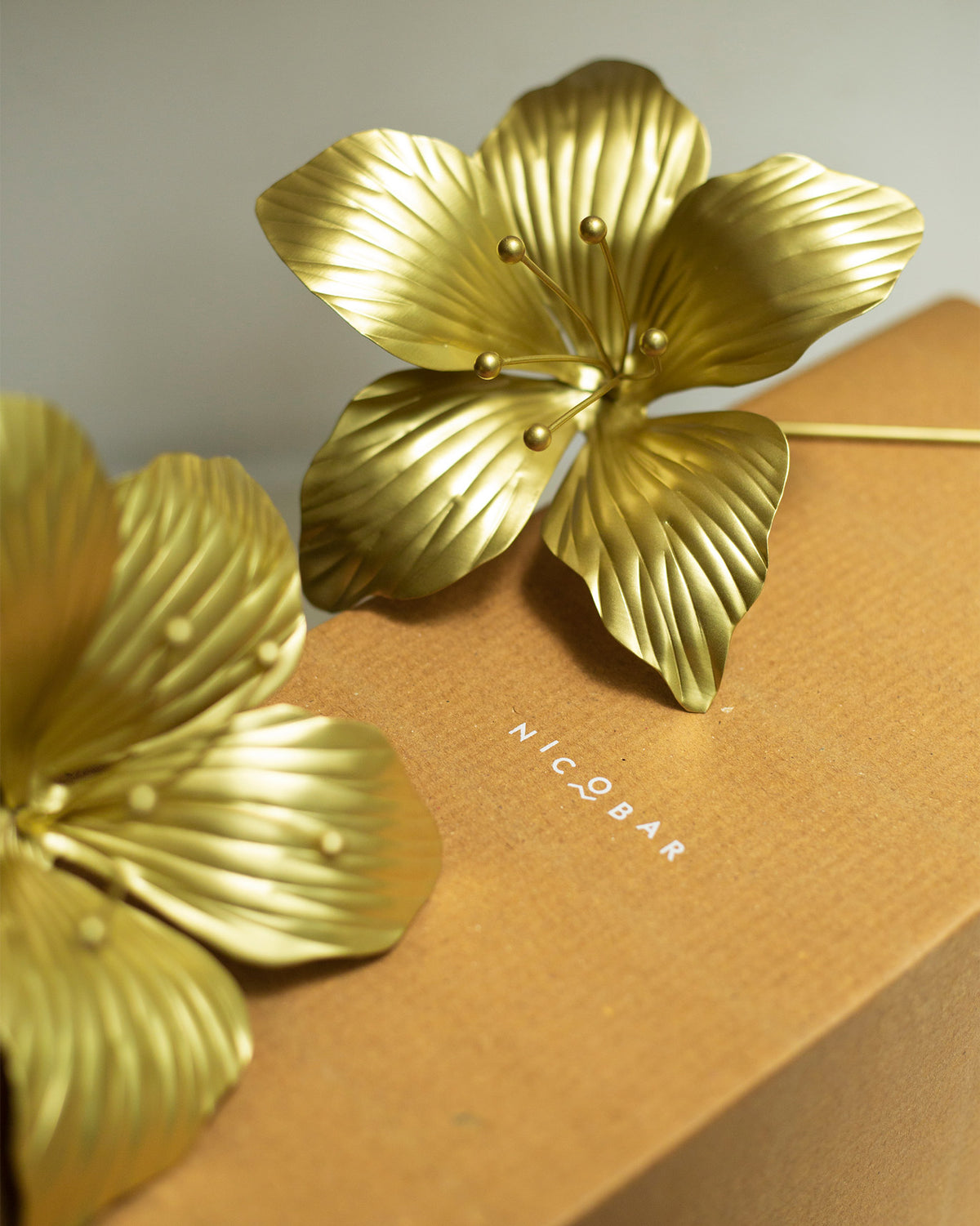 Close-up of gold Kachnar flower accents on a Nicobar box.