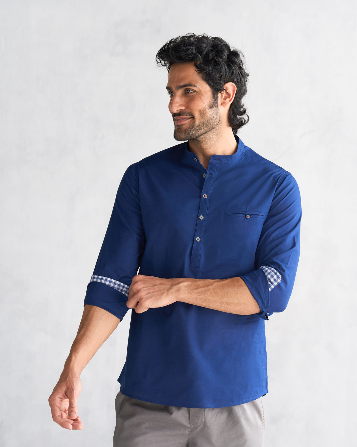 Person wearing a blue Pondicherry shirt with rolled sleeves and a chest pocket.