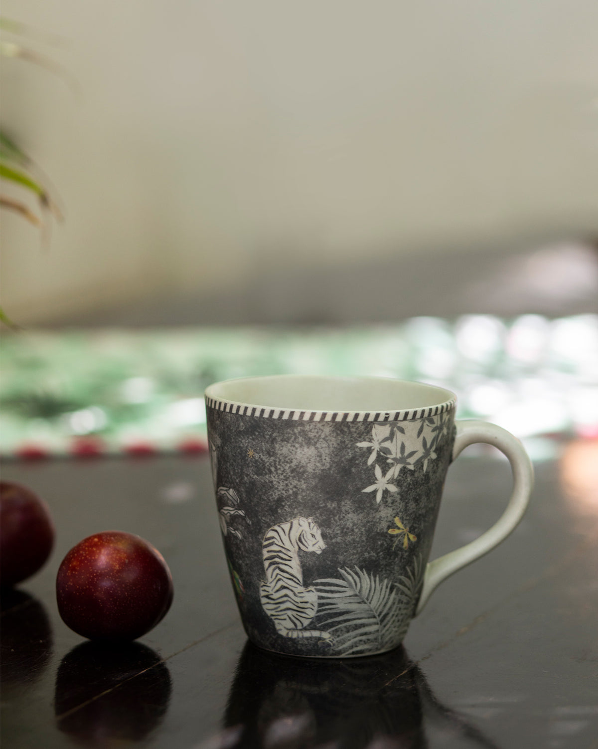 Periyar Mug Charcoal with a tiger and flowers on the side.