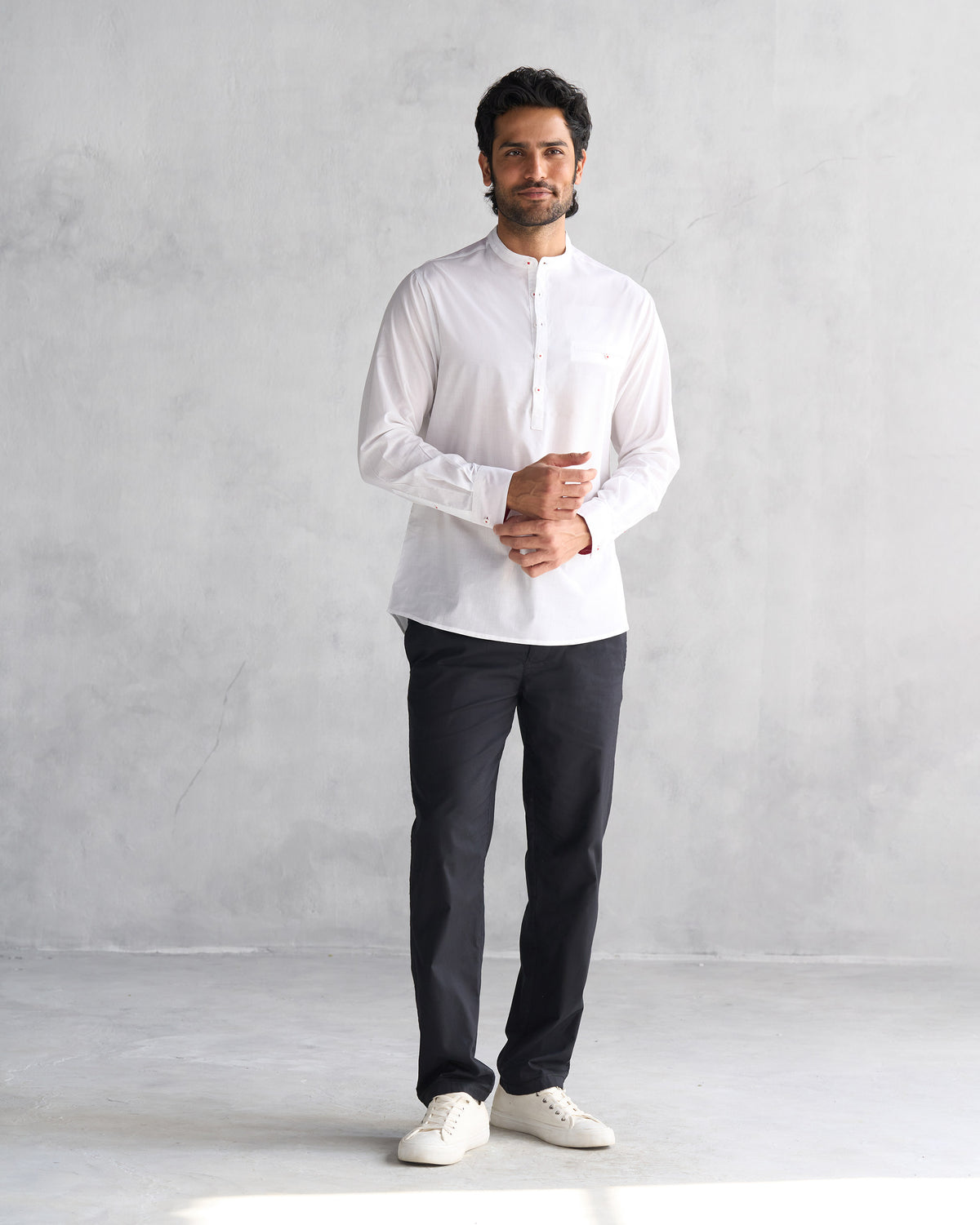 Full-length view of a white Pondicherry shirt worn by a person.