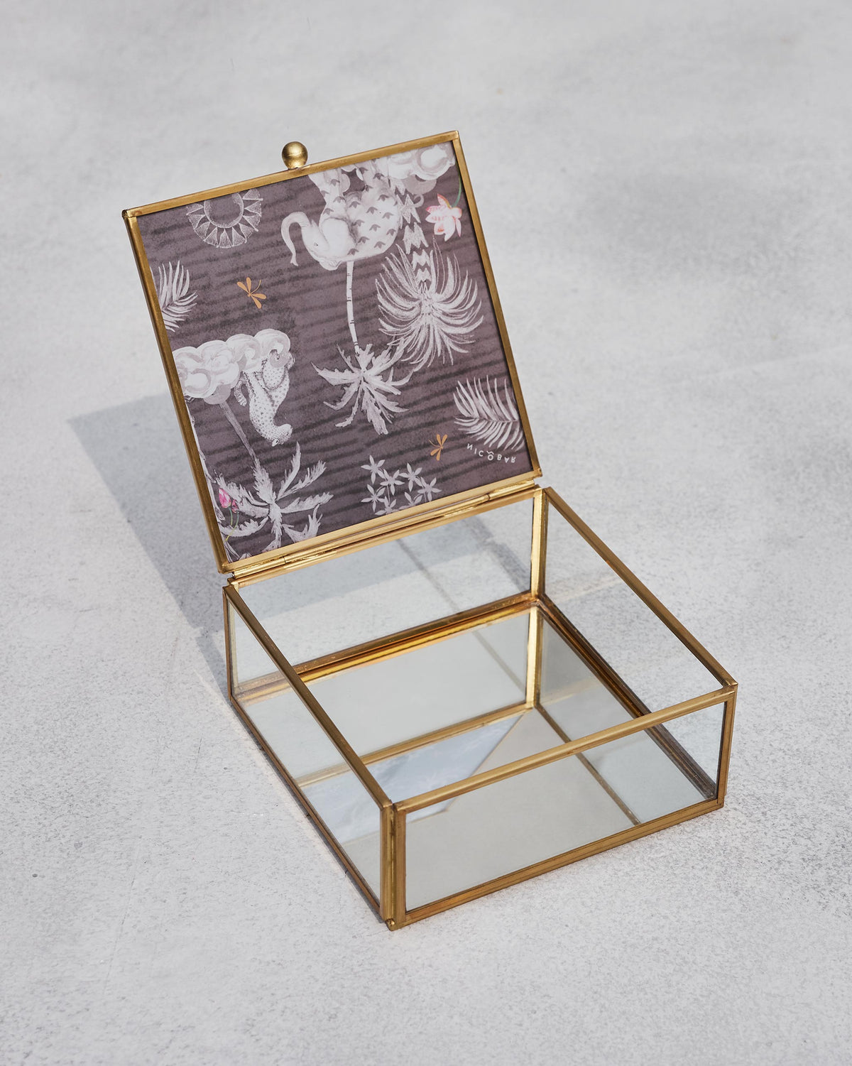 Open Periyar jewellery box showing its glass interior and printed lid.