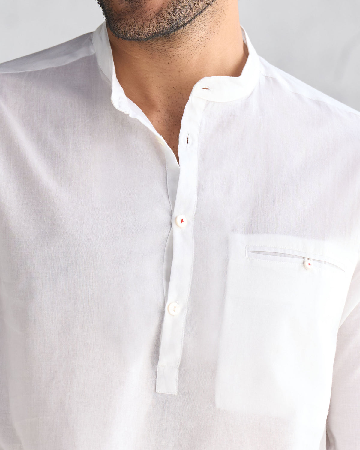 Close-up of a white Pondicherry Kurta showing the open collar and chest pocket.