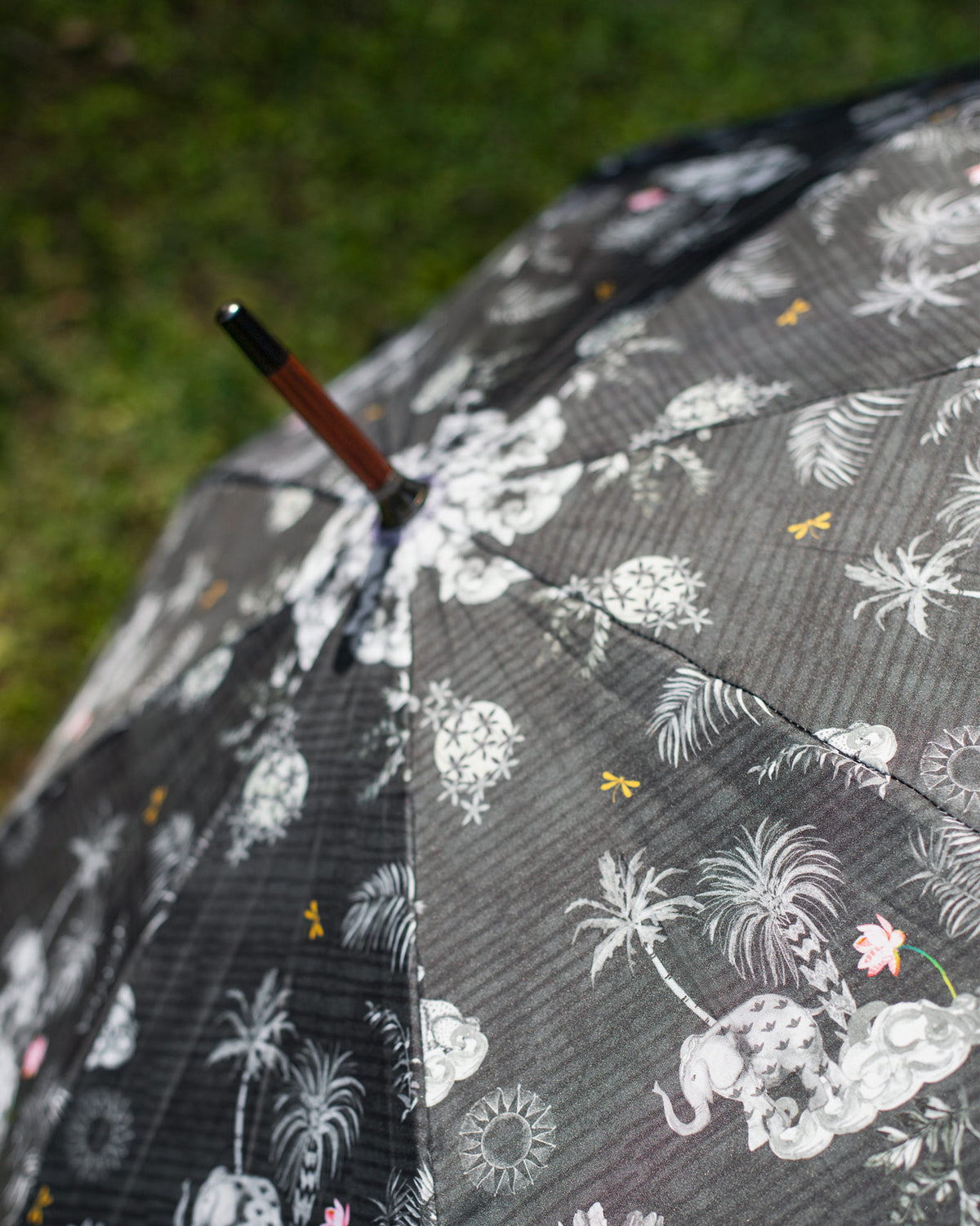 Close-up of the Periyar Umbrella canopy showing its white palm and elephant print.