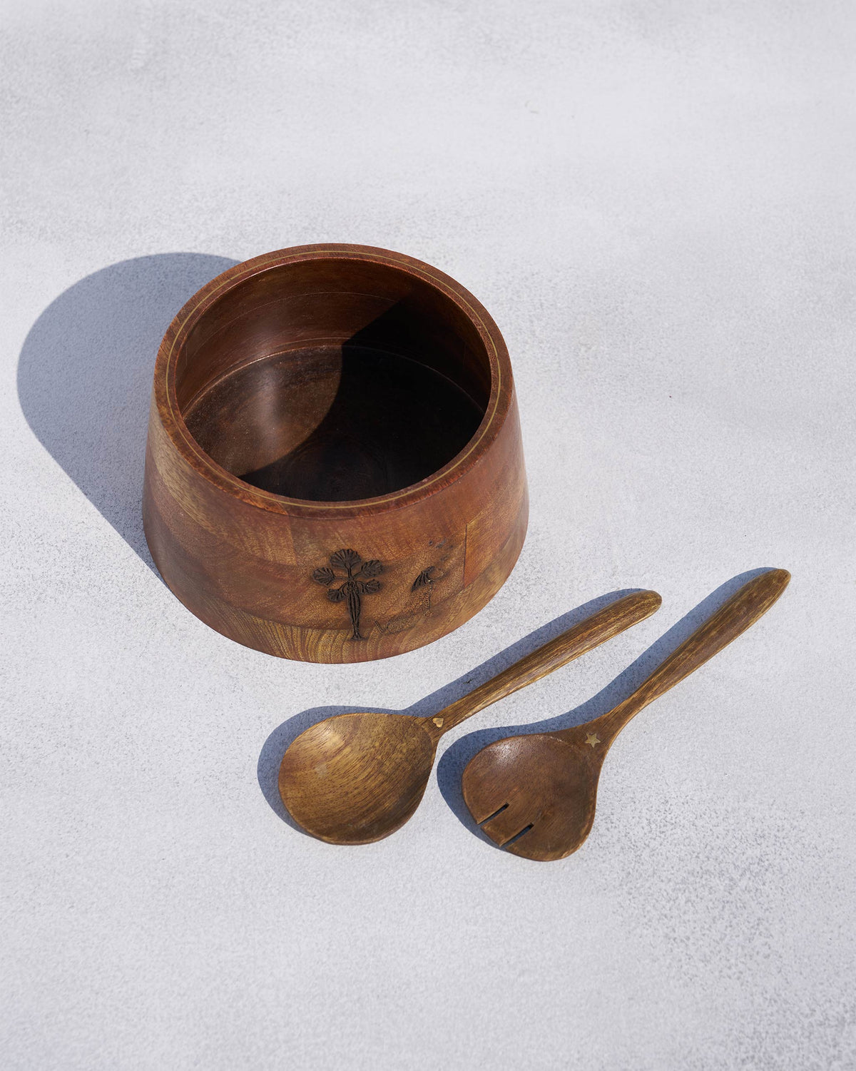 Bara salad bowl with wooden spoon and fork servers featuring gold star accents.