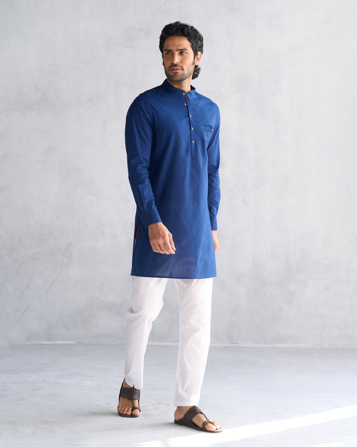 Navy Pondicherry kurta worn full length with white trousers.
