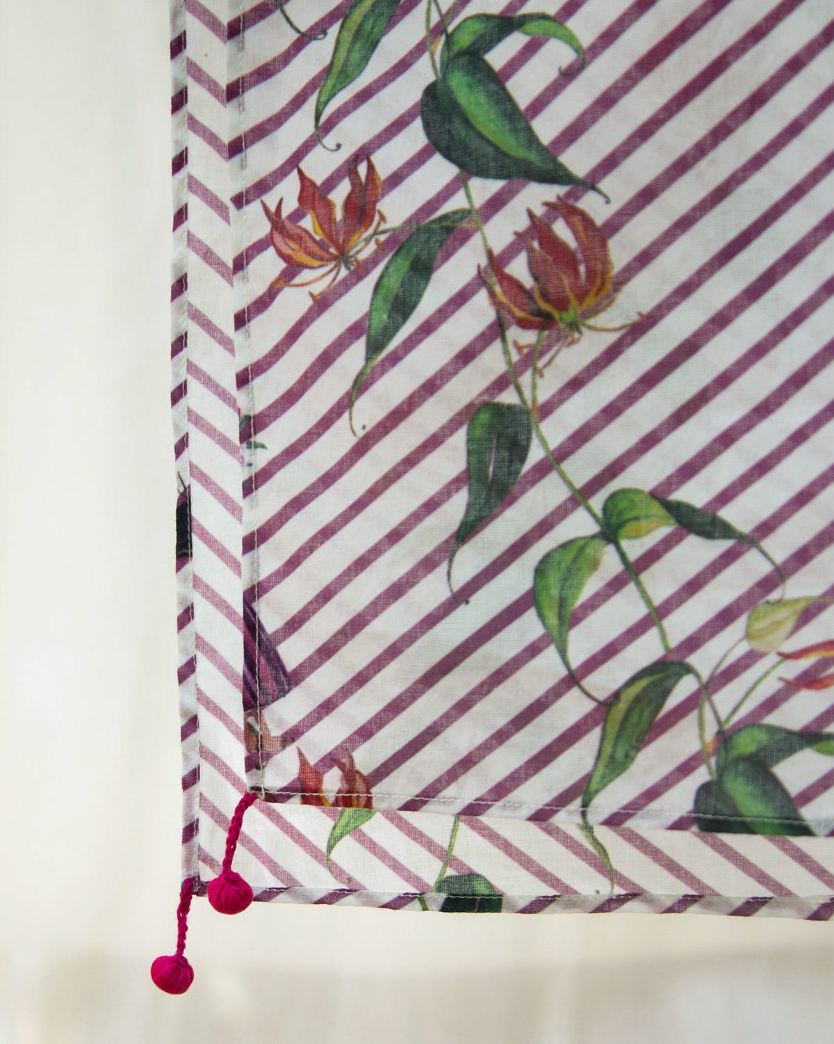 Close-up of the Riverine Sarong showing its pink pom-pom corner tassels.