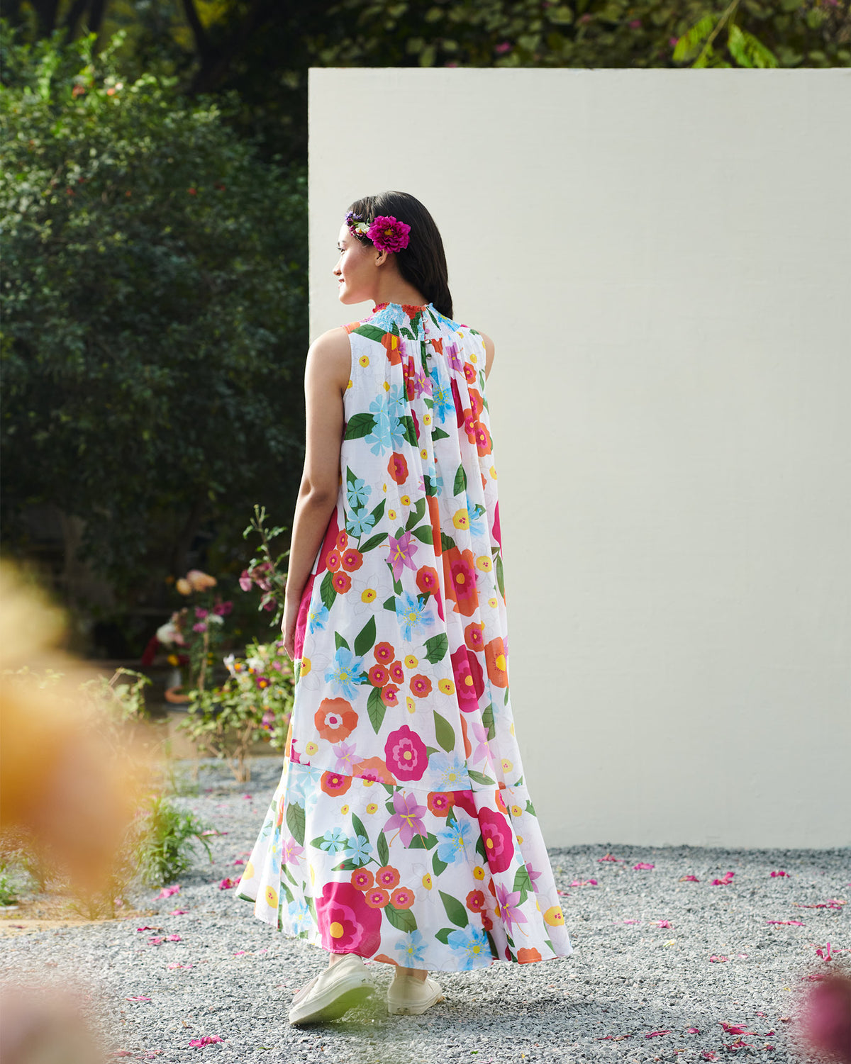 Back of a smocked neck dress worn by a person.