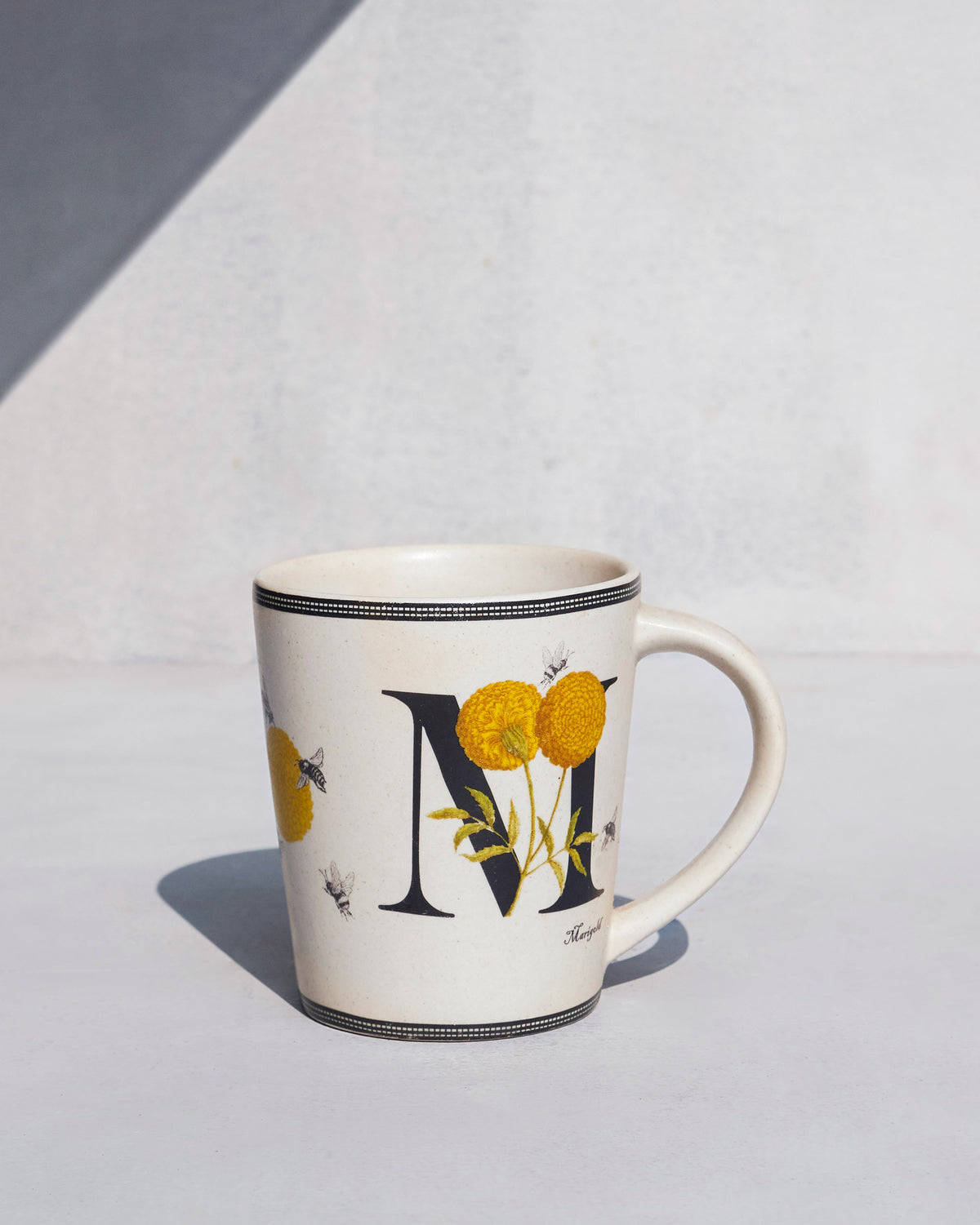 The charcoal M with marigolds.