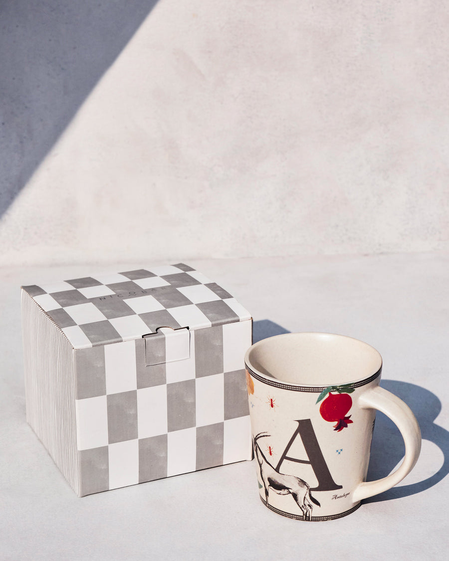 The Ananas Mug beside its chequered Nicobar gift box.