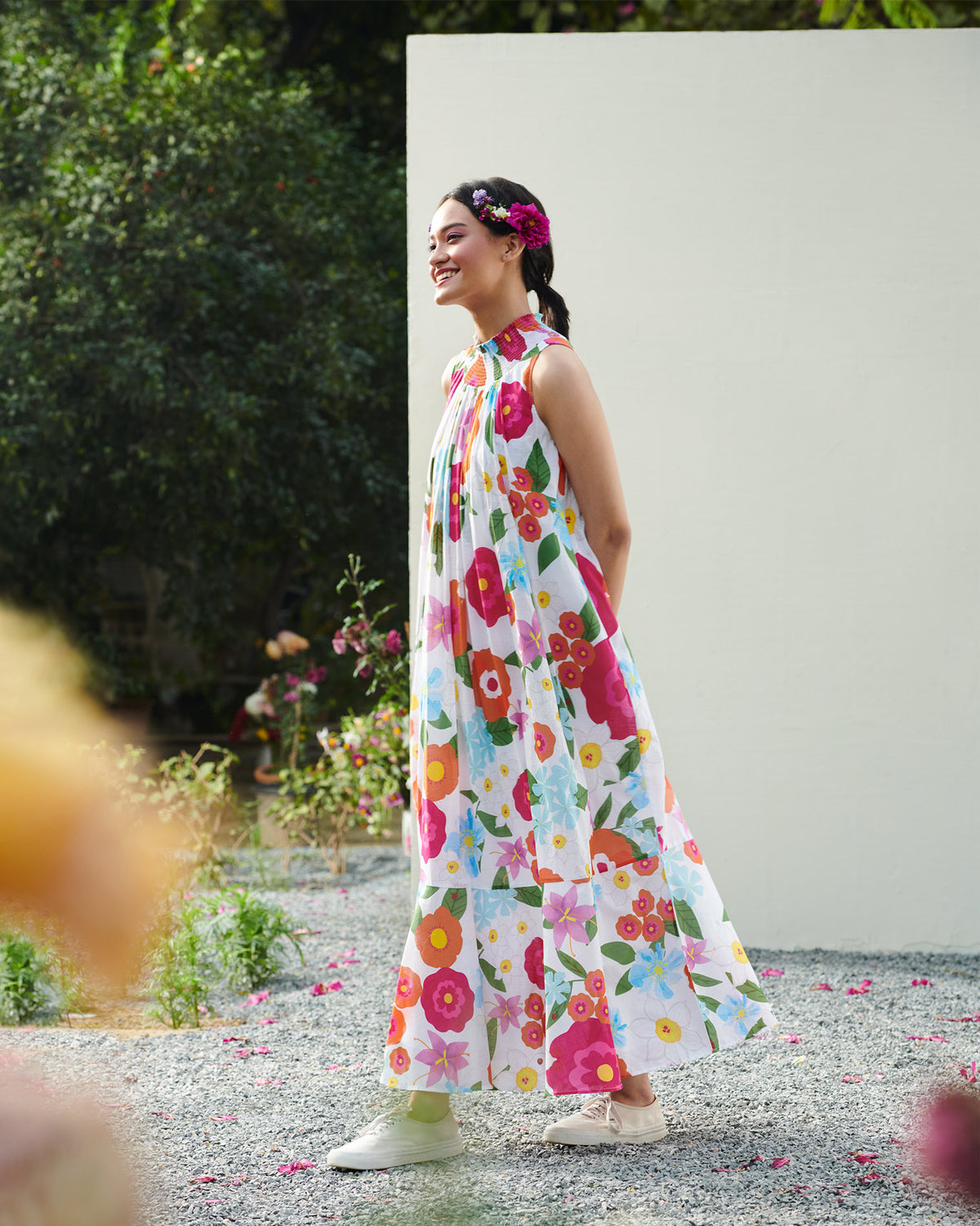 Side view of a smocked neck dress worn by a person.