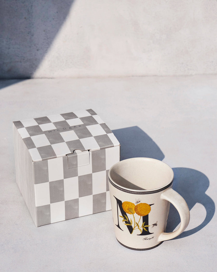 The Machli Mug beside its chequered Nicobar gift box.