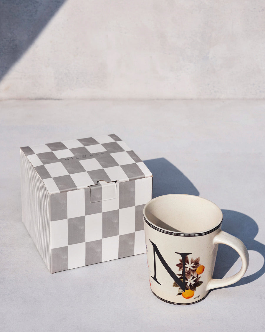The Nico Mug beside its chequered Nicobar gift box.