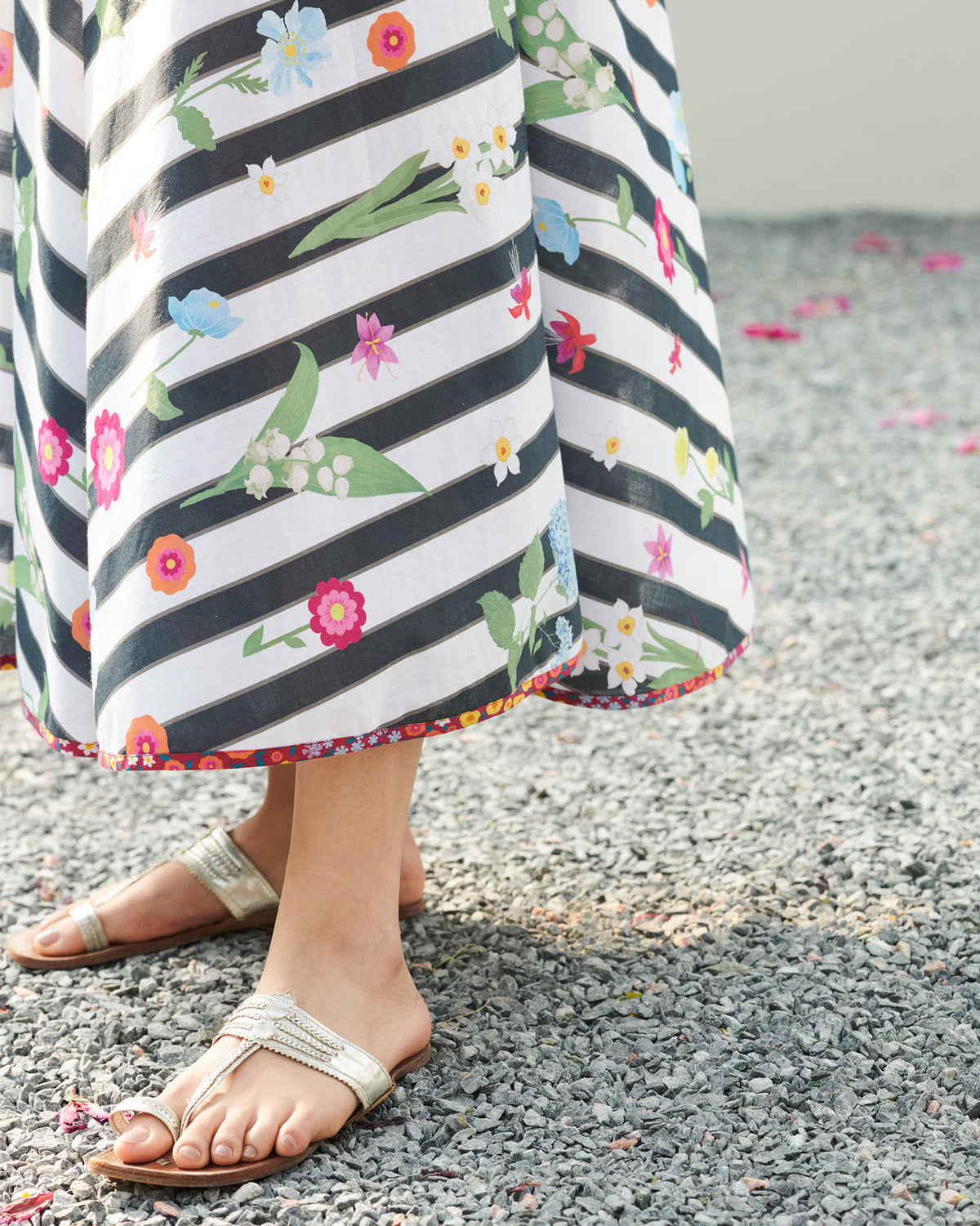 Close-up of the floral hem trim on a black and white striped dress.