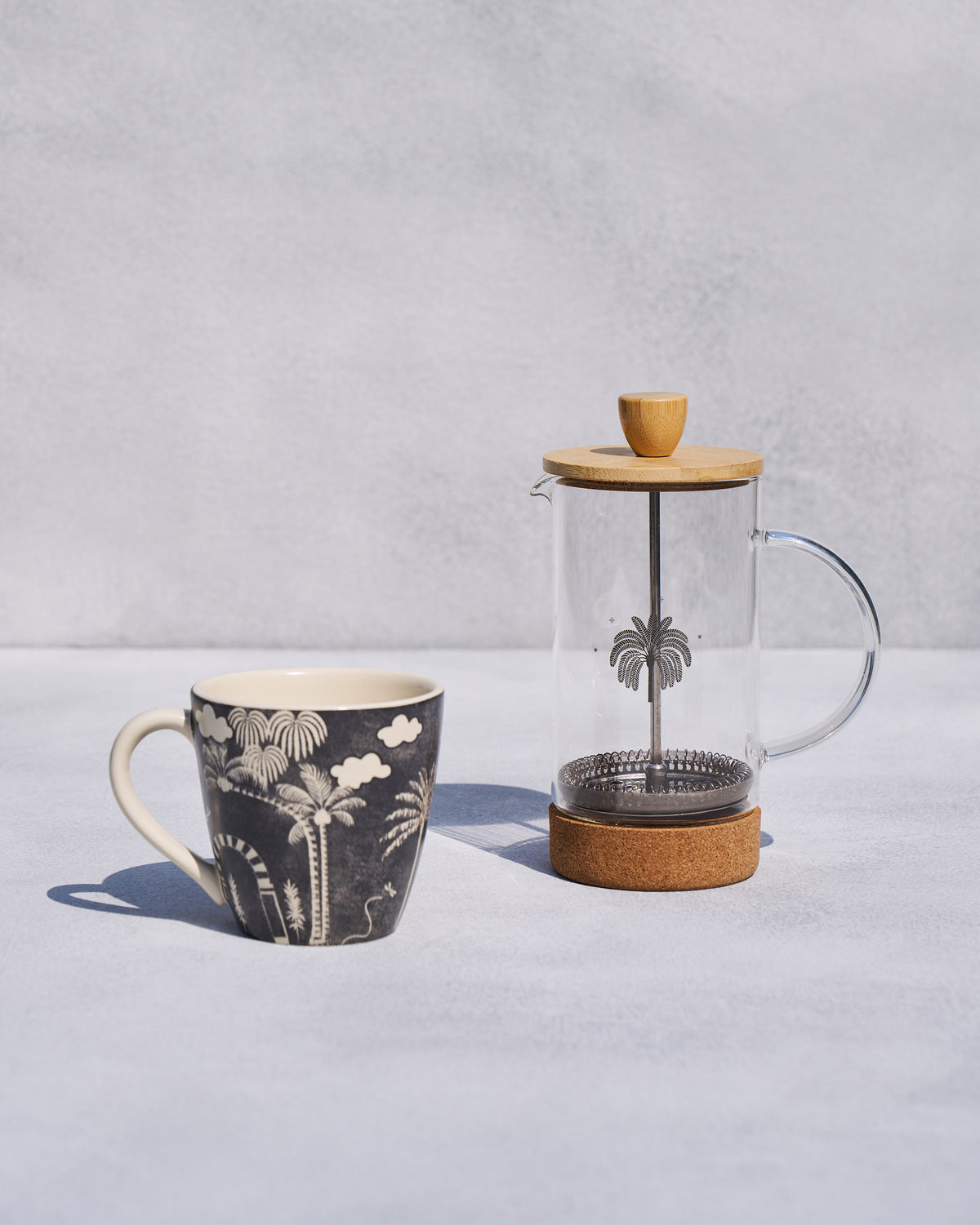 The Toddy French Press beside its palm-print mug.