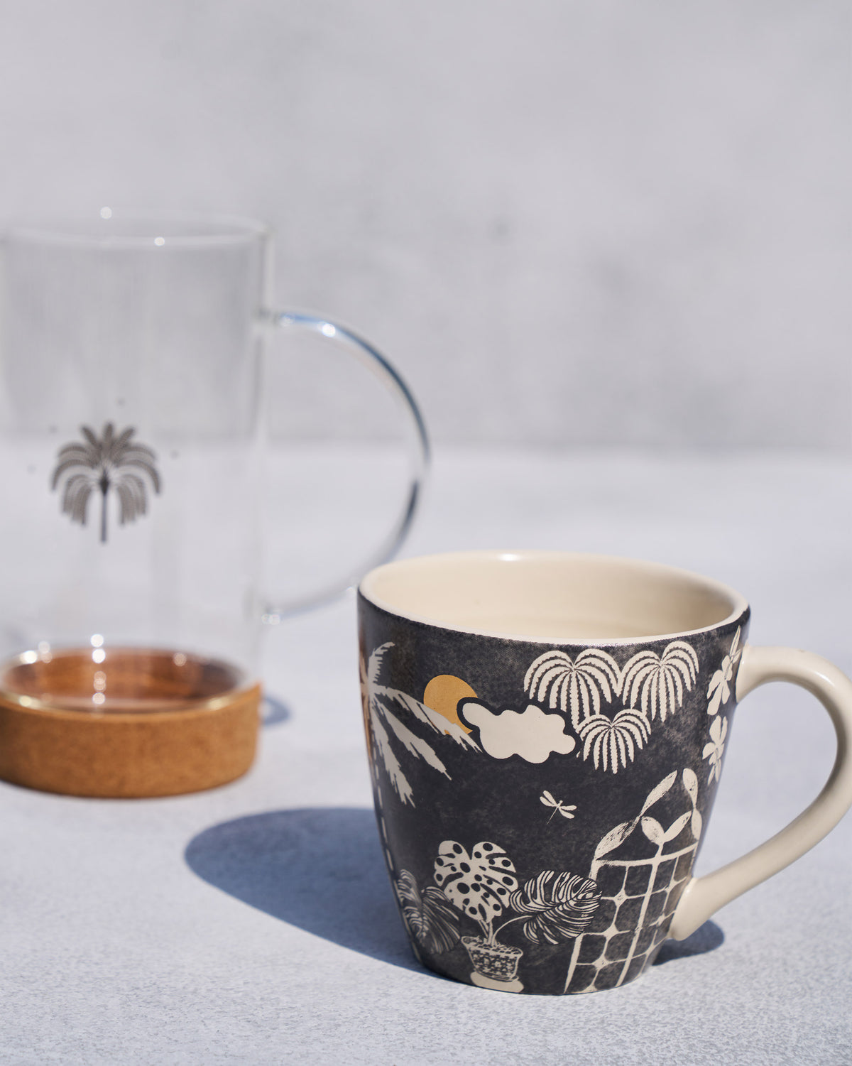 Palms, a cloud and a gold sun on the mug.